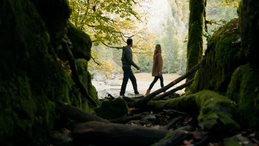 Ein Paar genießt einen romantischen Spaziergang durch die moosigen Wälder des Urlaub Ausseerlandes in Österreich.